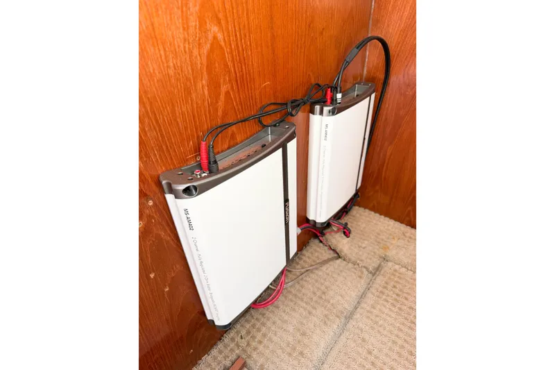 Slide: The Image of Audio amplifiers installed on a wooden panel in a 1988 Pacemaker 36 Convertible boat. - 101