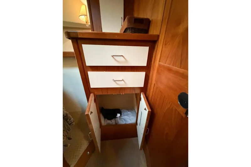 Slide: The Image of Interior storage area of 1988 Pacemaker 36 Convertible boat with wooden cabinetry. - 104