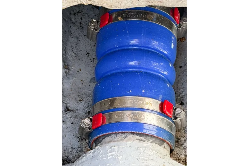 Slide: The Image of Blue hose with metal clamps on a 1988 Pacemaker 36 Convertible boat. - 108