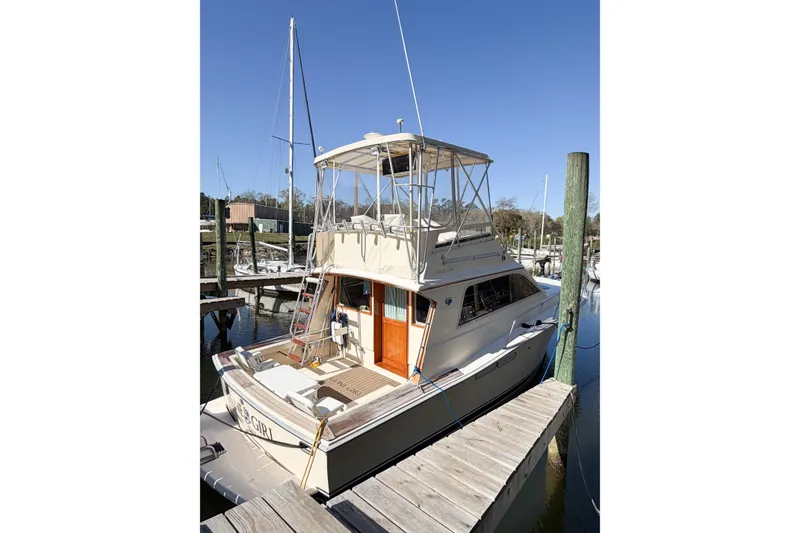 Slide: The Image of 1988 Pacemaker 36 Convertible yacht docked at marina under clear blue sky. - 11