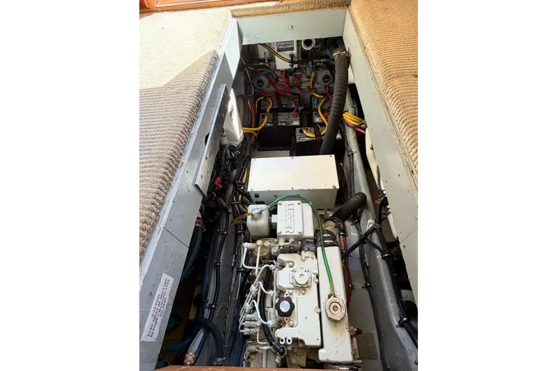 Slide: The Image of Engine compartment of a 1988 Pacemaker 36 Convertible boat, showcasing mechanical components. - 113