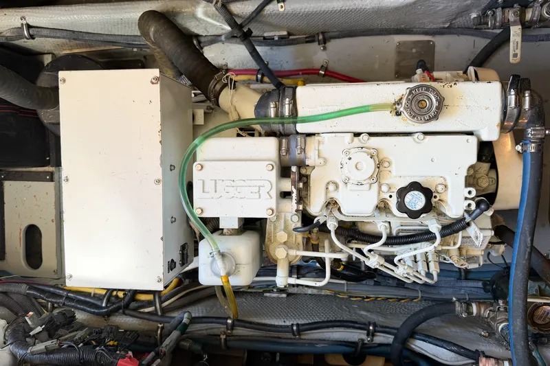 Slide: The Image of Engine compartment of a 1988 Pacemaker 36 Convertible boat, featuring a Lugger engine. - 115