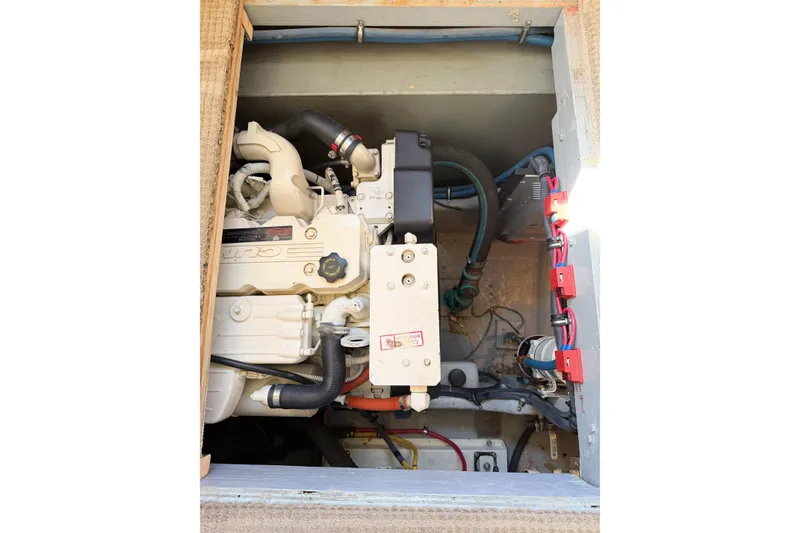 Slide: The Image of Engine compartment of a 1988 Pacemaker 36 Convertible boat, showcasing mechanical components and wiring. - 116