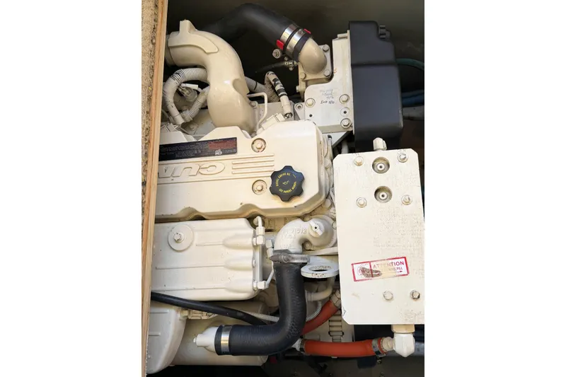 Slide: The Image of Engine compartment of a 1988 Pacemaker 36 Convertible boat, featuring Cummins components. - 117