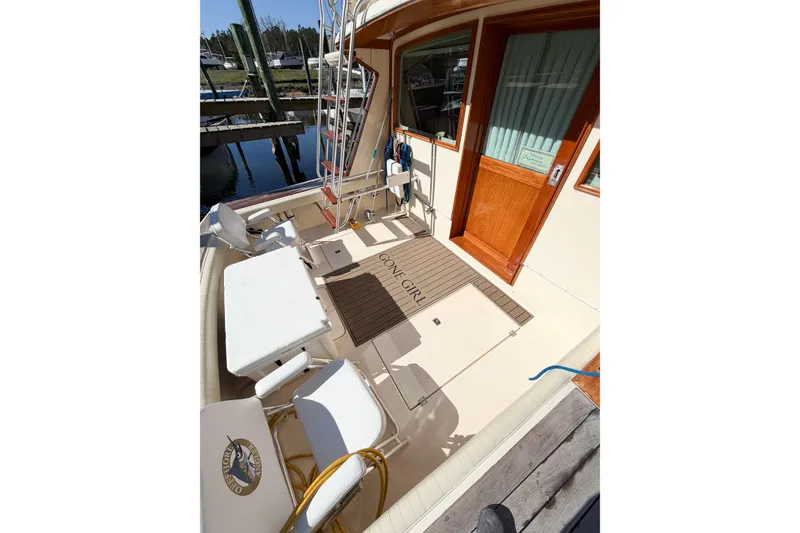 Slide: The Image of 1988 Pacemaker 36 Convertible yacht deck with seating and wooden door. - 15