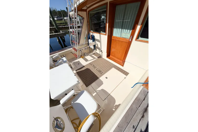 Slide: The Image of 1988 Pacemaker 36 Convertible boat deck with seating and wooden door. - 16
