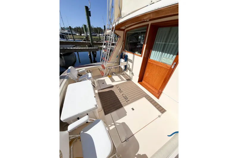 Slide: The Image of 1988 Pacemaker 36 Convertible yacht deck with seating and wooden door. - 18