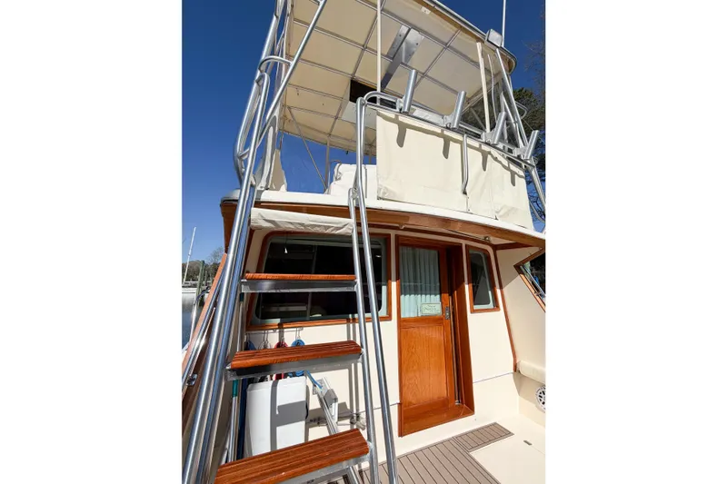 Slide: The Image of 1988 Pacemaker 36 Convertible boat with wooden accents and upper deck ladder. - 21
