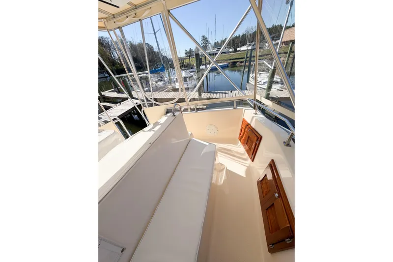 Slide: The Image of 1988 Pacemaker 36 Convertible boat interior with seating and marina view. - 25