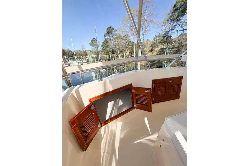 Slide: The Image of 1988 Pacemaker 36 Convertible boat with open wooden storage compartments on deck. - 26