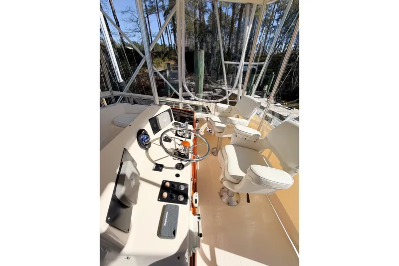 Slide: The Image of Interior view of 1988 Pacemaker 36 Convertible boat cockpit with steering wheel and seats. - 27