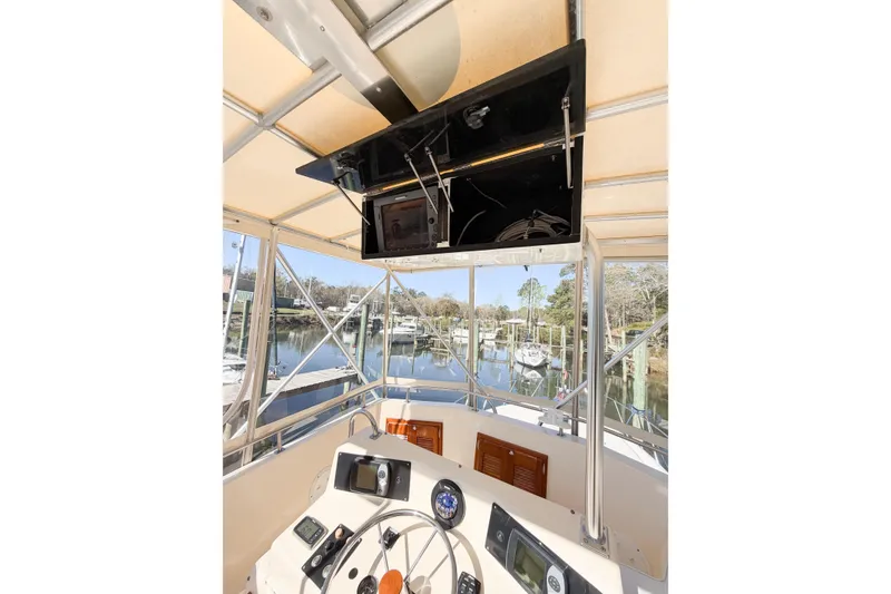 Slide: The Image of 1988 Pacemaker 36 Convertible boat helm with navigation equipment and marina view. - 30