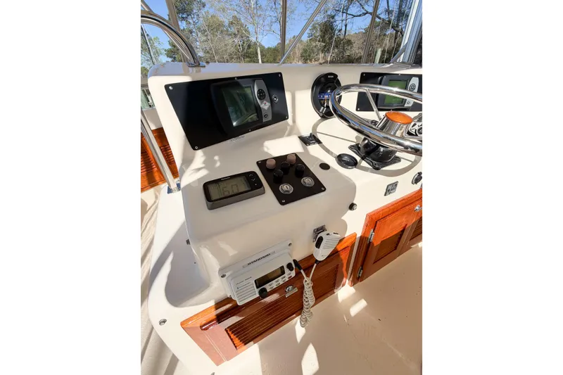 Slide: The Image of 1988 Pacemaker 36 Convertible boat helm with steering wheel and navigation controls. - 33
