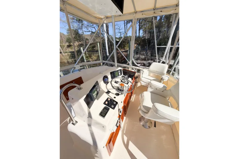 Slide: The Image of Helm of 1988 Pacemaker 36 Convertible boat with modern controls and seating. - 35