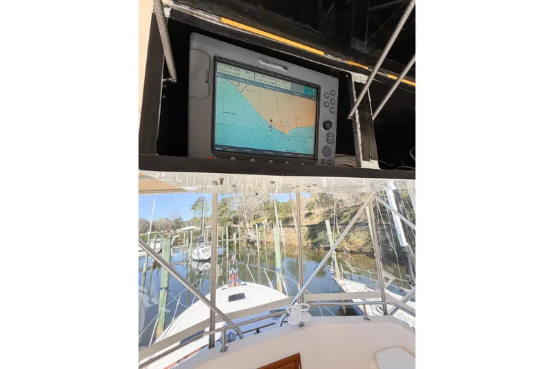 Slide: The Image of 1988 Pacemaker 36 Convertible boat with navigation system and marina view. - 38