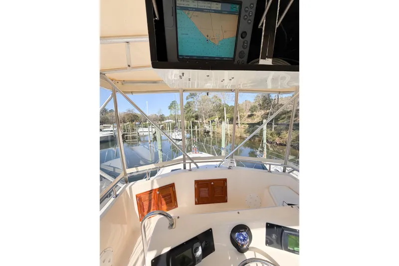 Slide: The Image of 1988 Pacemaker 36 Convertible boat cockpit with navigation equipment and scenic marina view. - 40