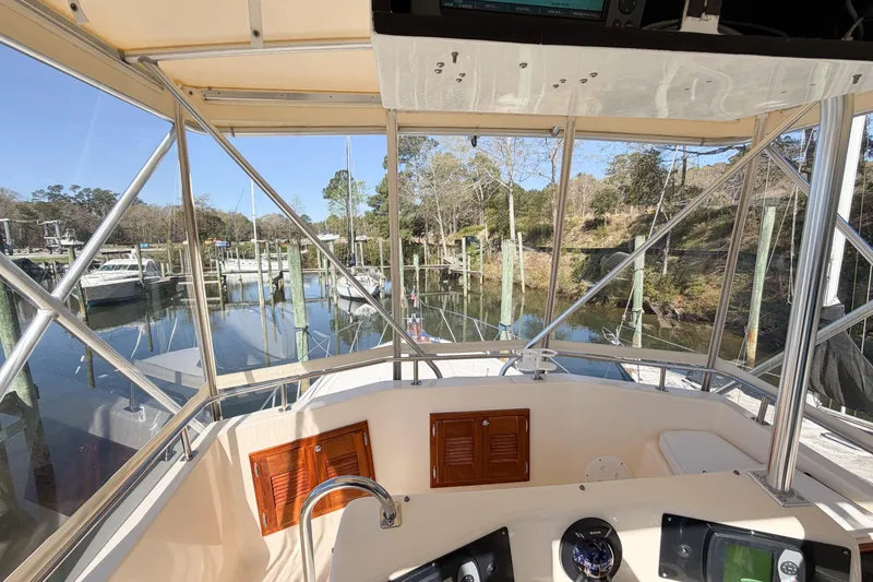 Slide: The Image of Cockpit view of 1988 Pacemaker 36 Convertible yacht docked in a serene marina. - 41