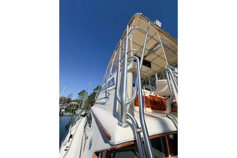 Slide: The Image of 1988 Pacemaker 36 Convertible yacht with metal railings against clear blue sky. - 45