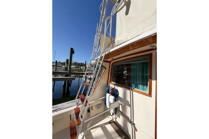 Slide: The Image of 1988 Pacemaker 36 Convertible yacht with exterior ladder and dock view. - 47