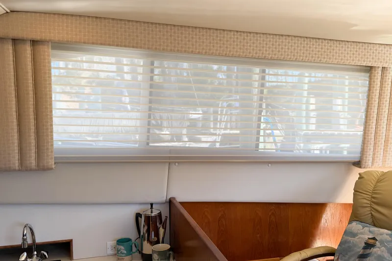 Slide: The Image of Interior of 1988 Pacemaker 36 Convertible yacht with window blinds and cozy seating area. - 52