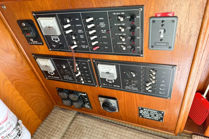 Slide: The Image of Control panel of a 1988 Pacemaker 36 Convertible boat with various switches and gauges. - 56