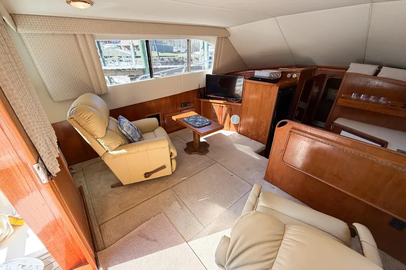 Slide: The Image of Interior of 1988 Pacemaker 36 Convertible yacht with cozy seating and wooden furnishings. - 57