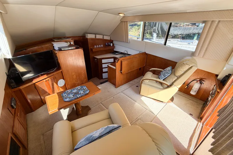 Slide: The Image of Interior of a 1988 Pacemaker 36 Convertible yacht with cozy seating and wooden cabinetry. - 58