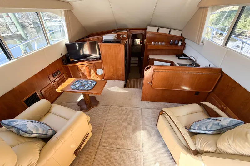Slide: The Image of Interior of a 1988 Pacemaker 36 Convertible yacht with cozy seating and a small kitchenette. - 59