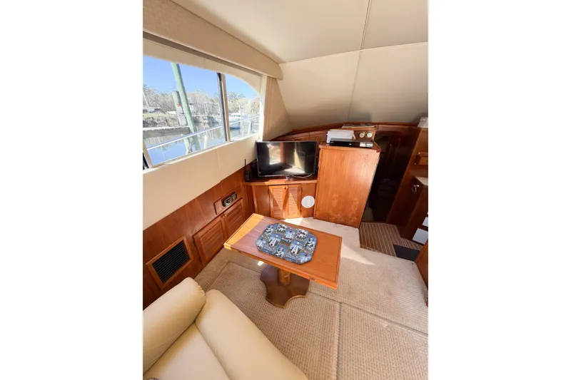 Slide: The Image of Interior of 1988 Pacemaker 36 Convertible yacht with cozy seating and a small TV. - 60