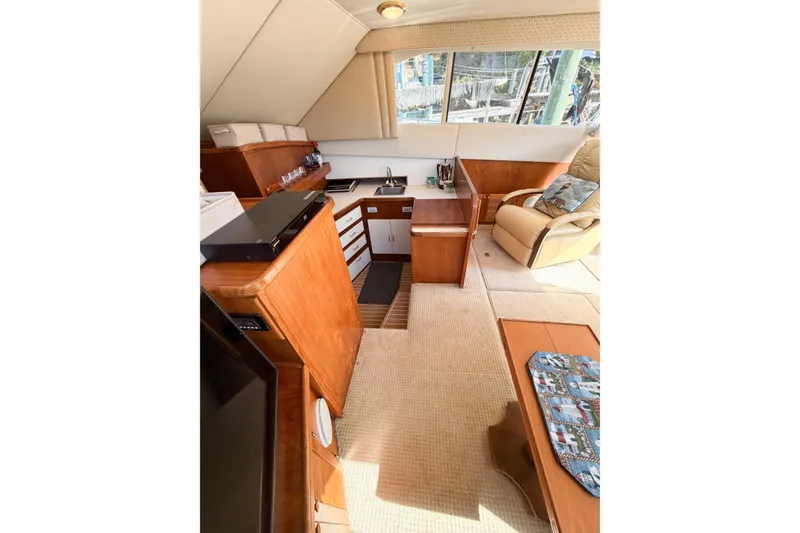 Slide: The Image of Interior of 1988 Pacemaker 36 Convertible yacht with wood cabinetry and comfortable seating. - 61