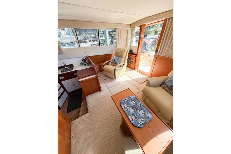 Slide: The Image of Interior of 1988 Pacemaker 36 Convertible yacht with cozy seating and wooden accents. - 62