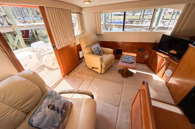 Slide: The Image of Interior of 1988 Pacemaker 36 Convertible yacht with cozy seating and wooden accents. - 64