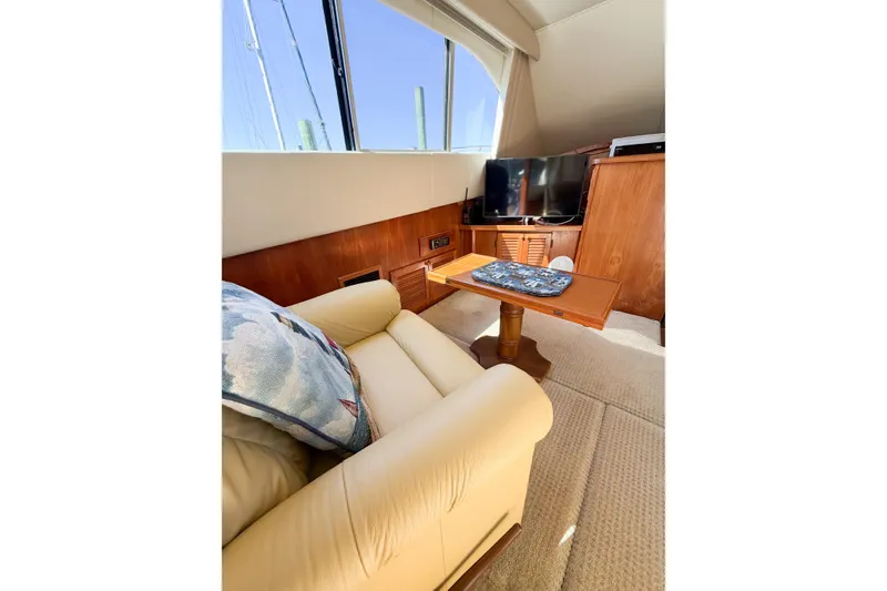Slide: The Image of Interior of 1988 Pacemaker 36 Convertible yacht with sofa, table, and TV. - 65