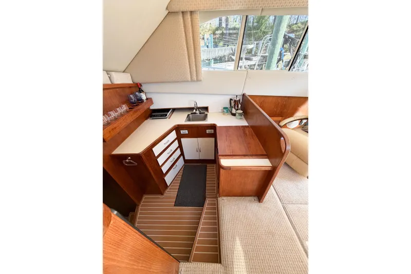Slide: The Image of Interior of 1988 Pacemaker 36 Convertible yacht with wooden cabinetry and compact kitchen area. - 66