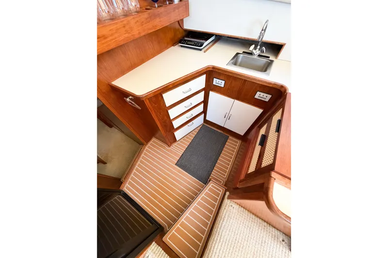 Slide: The Image of Interior view of 1988 Pacemaker 36 Convertible yacht kitchen area with wood cabinetry. - 67