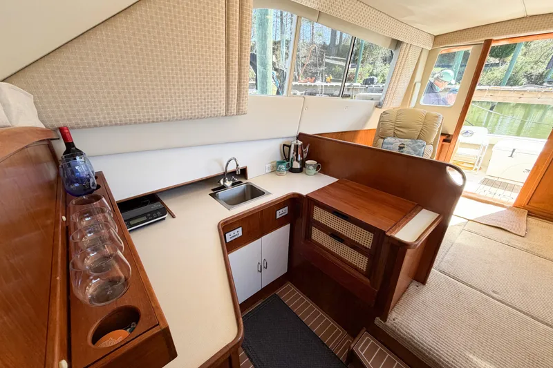 Slide: The Image of Interior of 1988 Pacemaker 36 Convertible yacht with kitchenette and seating area. - 68