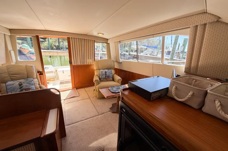 Slide: The Image of Interior of 1988 Pacemaker 36 Convertible yacht with cozy seating and large windows. - 70