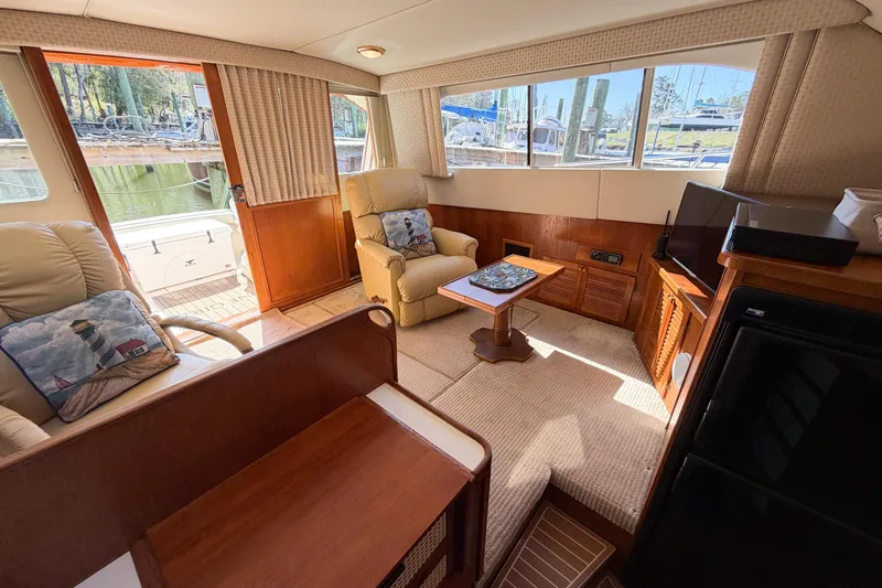 Slide: The Image of Interior of 1988 Pacemaker 36 Convertible yacht with cozy seating and nautical decor. - 71