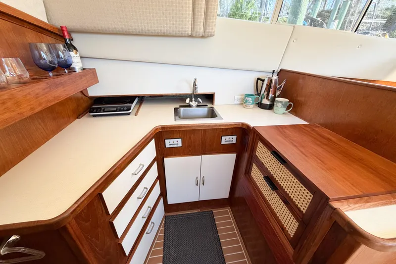 Slide: The Image of Compact kitchen in 1988 Pacemaker 36 Convertible yacht with wood cabinetry and modern amenities. - 72