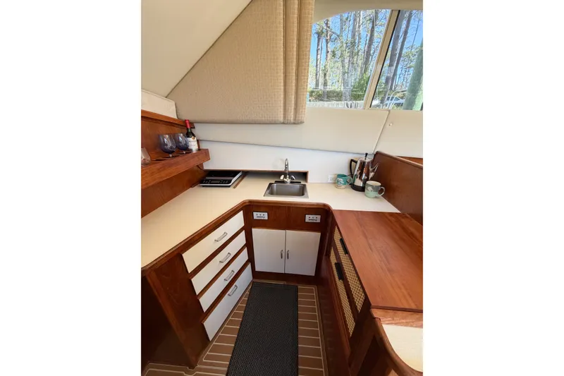 Slide: The Image of 1988 Pacemaker 36 Convertible yacht kitchen with wood cabinetry and modern amenities. - 73