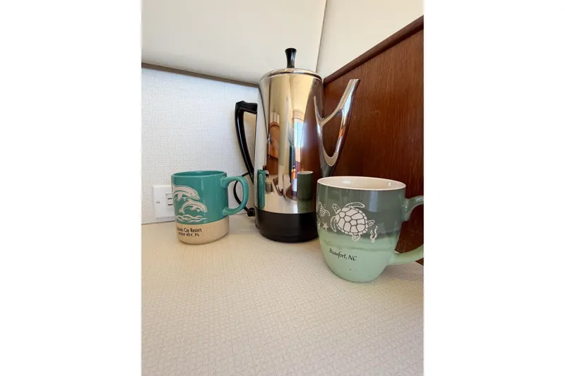 Slide: The Image of Two mugs and a coffee pot on a 1988 Pacemaker 36 Convertible boat. - 75