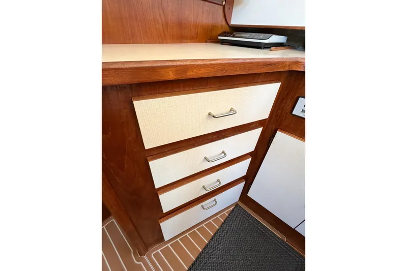 Slide: The Image of Wooden cabinetry with white drawers in a 1988 Pacemaker 36 Convertible boat interior. - 77