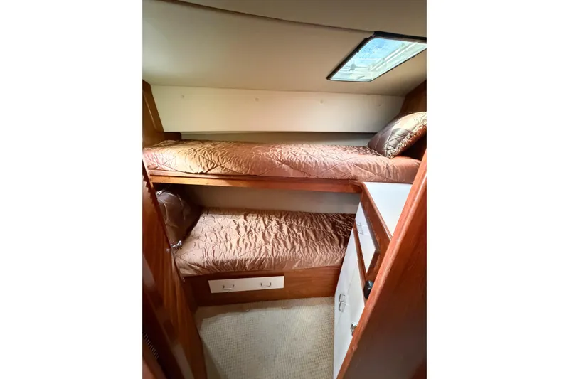 Slide: The Image of Interior of 1988 Pacemaker 36 Convertible with cozy bunk beds and wooden cabinetry. - 81