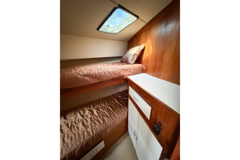 Slide: The Image of 1988 Pacemaker 36 Convertible cabin with bunk beds and wooden cabinetry. - 82