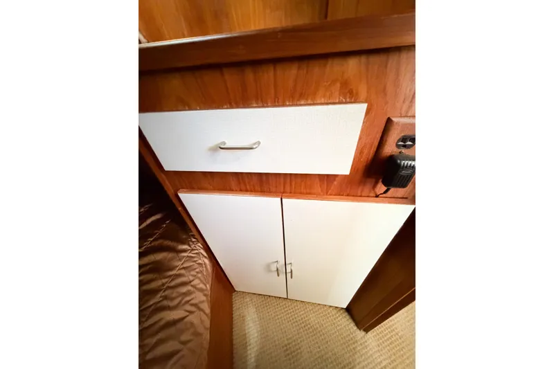 Slide: The Image of Wooden cabinetry with white doors in a 1988 Pacemaker 36 Convertible boat interior. - 84
