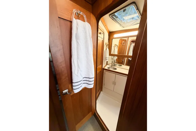 Slide: The Image of Bathroom interior of 1988 Pacemaker 36 Convertible yacht, featuring wood paneling and a skylight. - 85