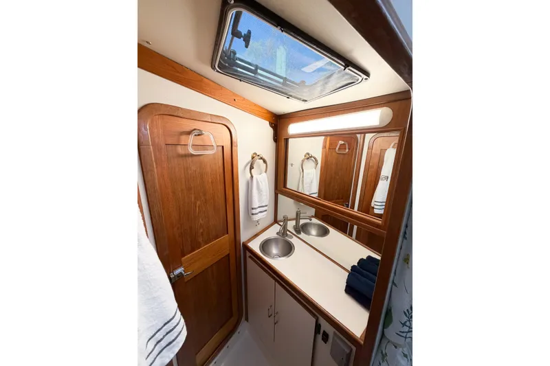 Slide: The Image of Compact bathroom in 1988 Pacemaker 36 Convertible yacht with wooden accents and dual sinks. - 86