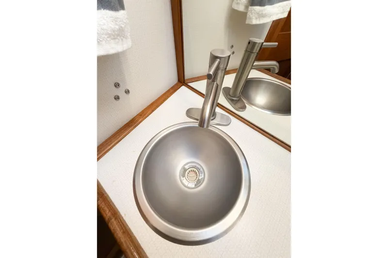 Slide: The Image of Stainless steel sink and faucet in 1988 Pacemaker 36 Convertible boat bathroom. - 87