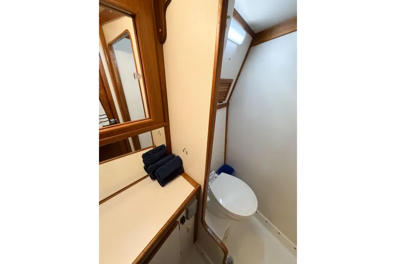 Slide: The Image of Bathroom interior of 1988 Pacemaker 36 Convertible yacht, featuring wooden accents and compact design. - 89