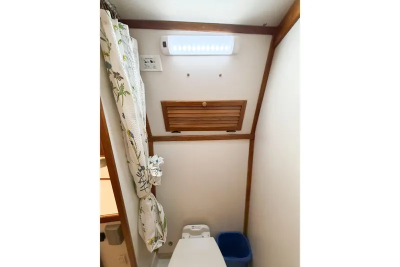 Slide: The Image of Small bathroom interior of 1988 Pacemaker 36 Convertible boat with curtain and vent. - 90